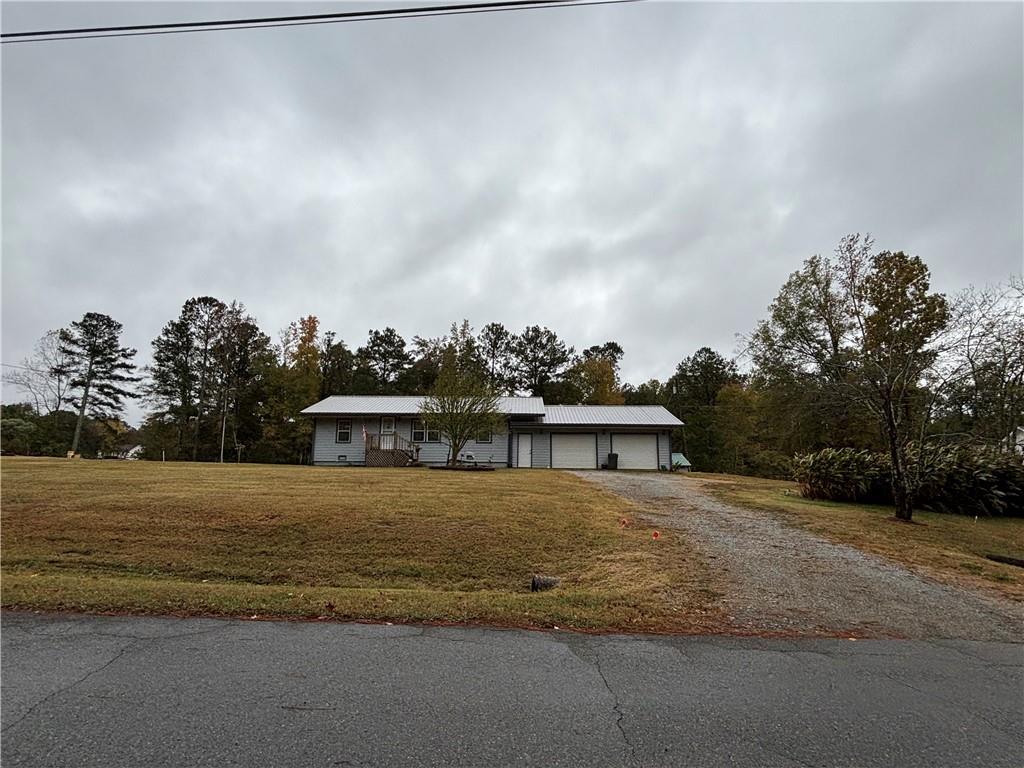 13 Black Road Northeast White, GA 30184 - Photo 2 of 31 a view of a big house with a big yard and large trees