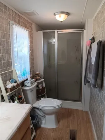 a bathroom with a toilet and a shower