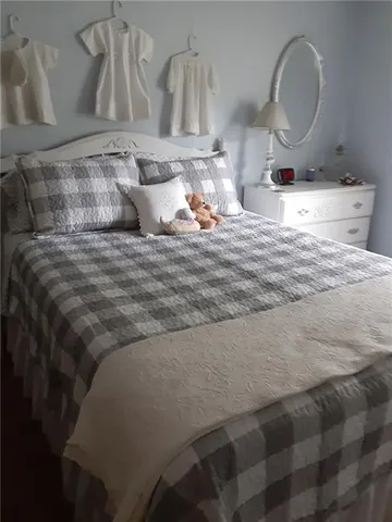 a view of a bedroom with furniture