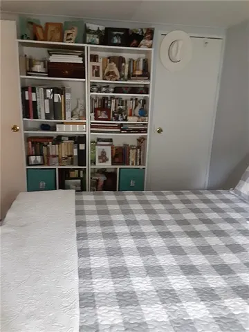 a room with a window and a dresser