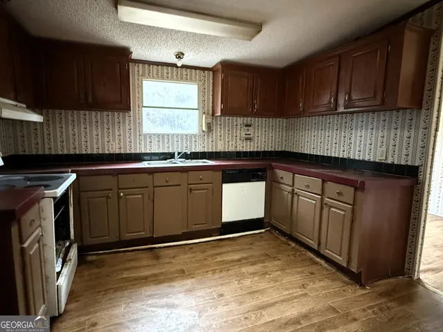 a kitchen with sink cabinets and window