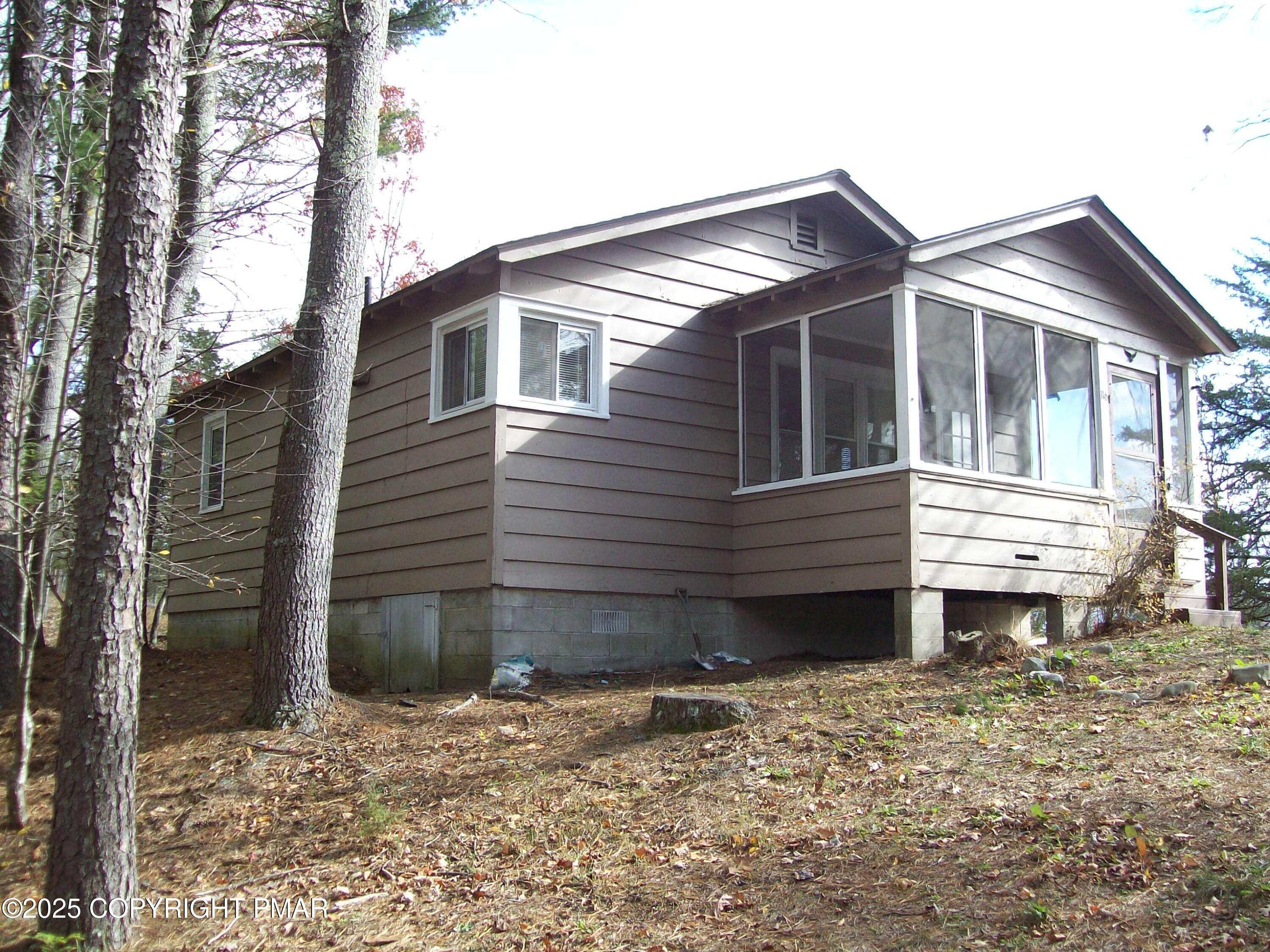 a view of a house with a yard and wooden fence