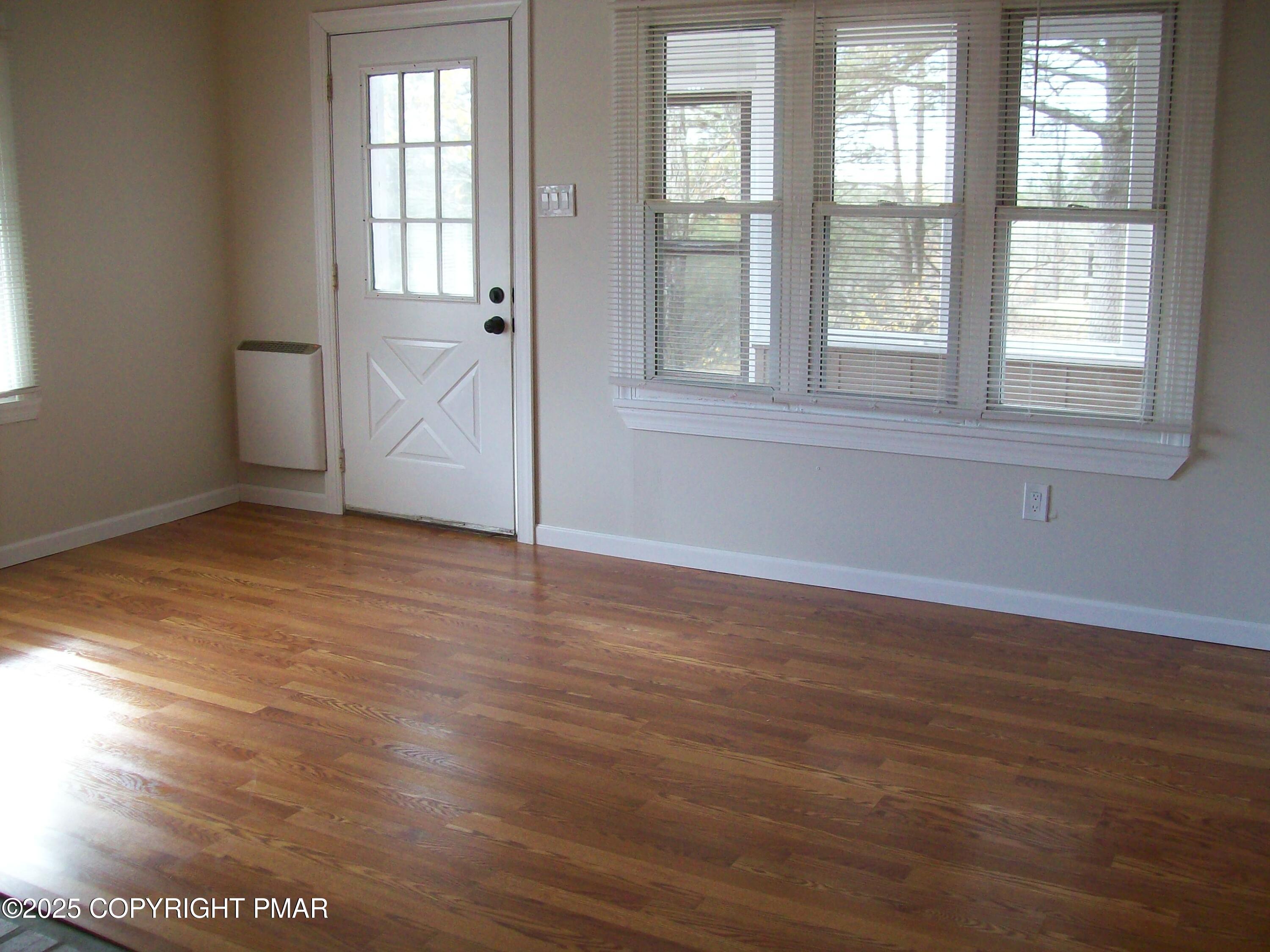 116 Kasak Road East Stroudsburg, PA 18302 - Photo 8 of 17 an empty room with wooden floor and windows