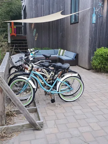 a table and chairs with potted plants in front of it