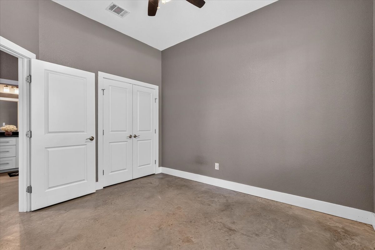 145 Cardinal Loop Paige, TX 78659 - Photo 39 of 40 Functional floorplan with concrete flooring and ample closet space.