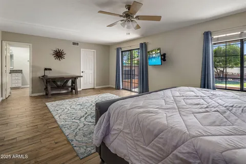a bedroom with a large bed and a chandelier