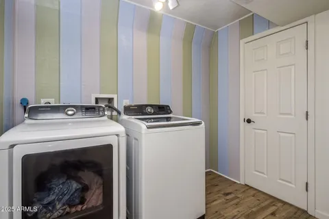 a view of washer and dryer with wooden floor