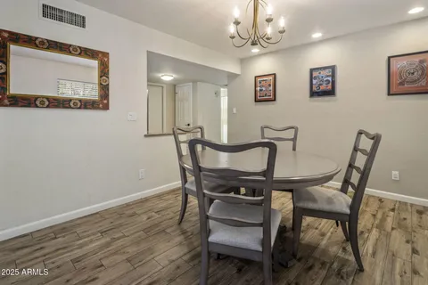 a view of a dining room with furniture and a chandelier