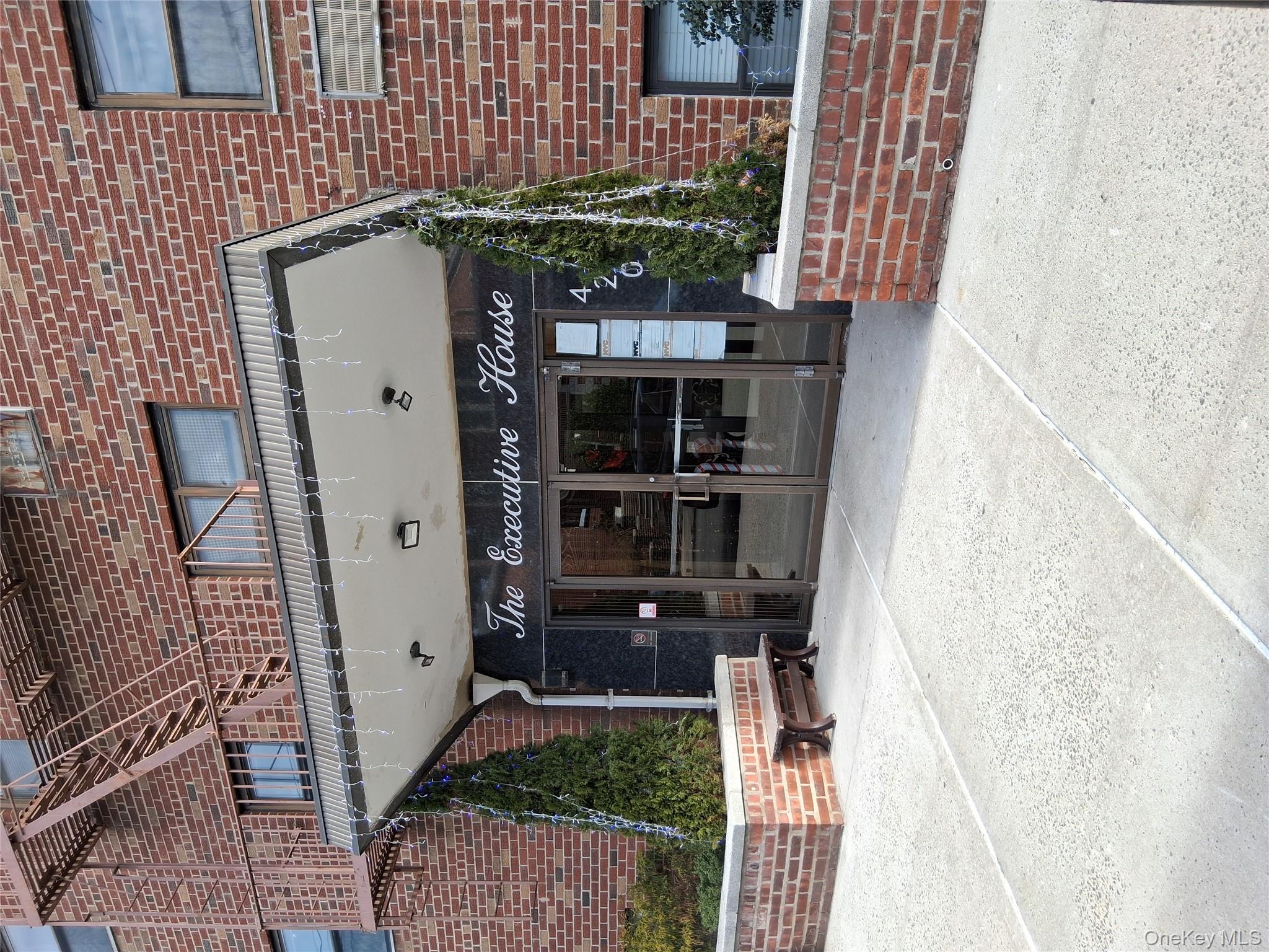 Property entrance featuring french doors and brick siding