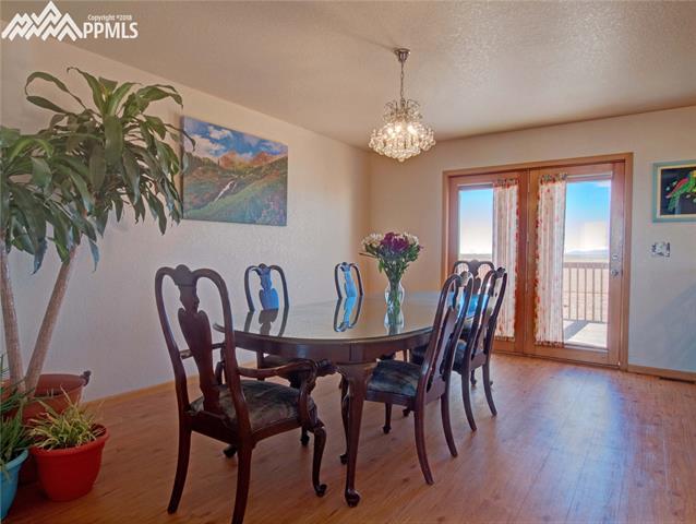 40250 Alford Road Simla, CO 80835 - Photo 12 of 26 This is the family room right off the kitchen. It is currently being used as the dining room. The doors exit onto the deck where you can enjoy views of Pikes Peak.