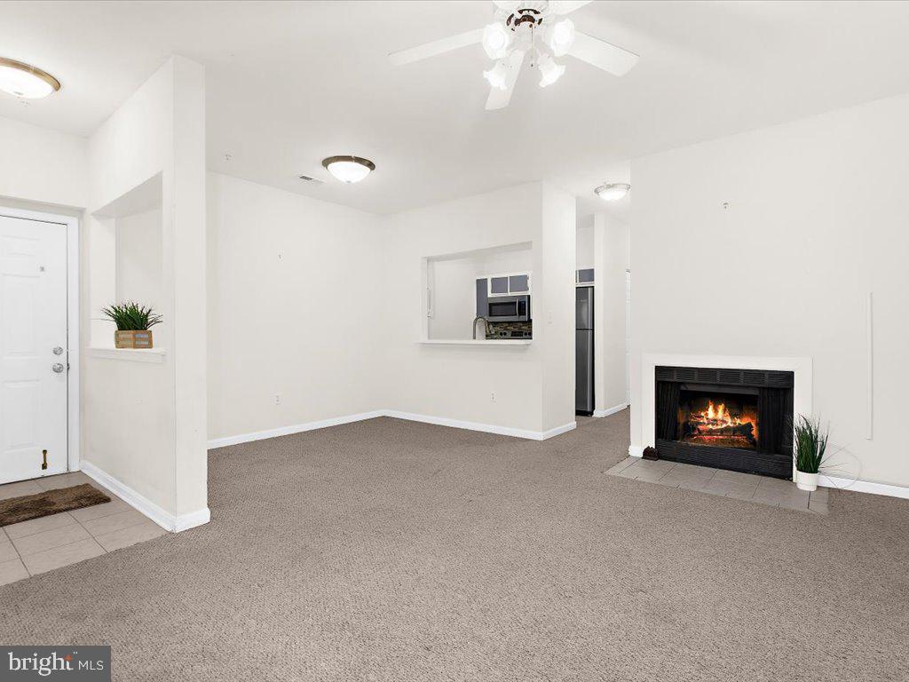 602 Moonglow Road, Unit 101 Odenton, MD 21113 - Photo 11 of 30 an empty room with windows and fireplace