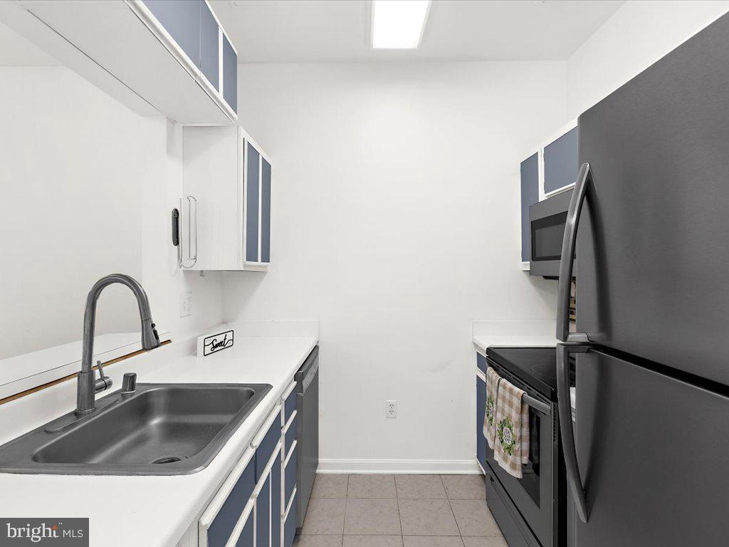 602 Moonglow Road, Unit 101 Odenton, MD 21113 - Photo 13 of 30 a kitchen with a sink and a refrigerator