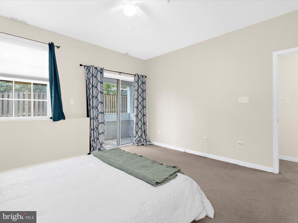 602 Moonglow Road, Unit 101 Odenton, MD 21113 - Photo 15 of 30 a bedroom with a bed and a large window