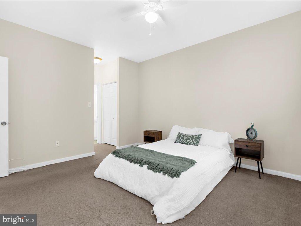 602 Moonglow Road, Unit 101 Odenton, MD 21113 - Photo 16 of 30 a bedroom with a bed and a night stand