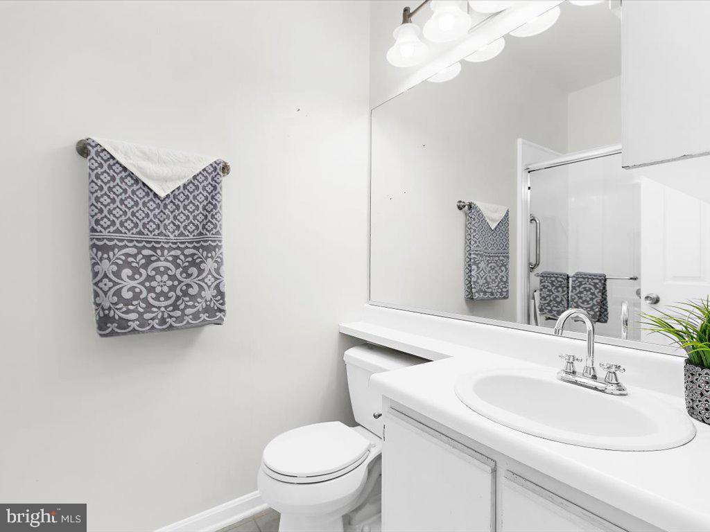 602 Moonglow Road, Unit 101 Odenton, MD 21113 - Photo 19 of 30 a bathroom with a sink a toilet and mirror