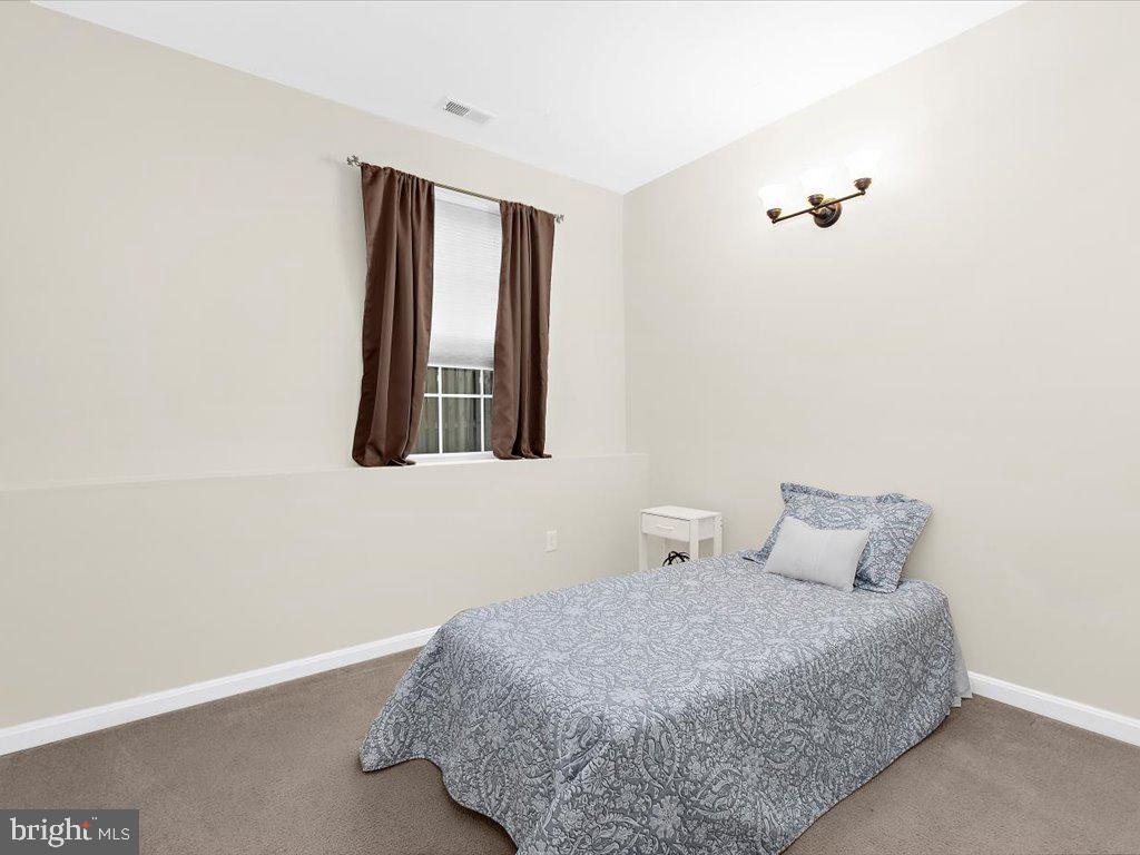 602 Moonglow Road, Unit 101 Odenton, MD 21113 - Photo 20 of 30 a bedroom with a bed and a window