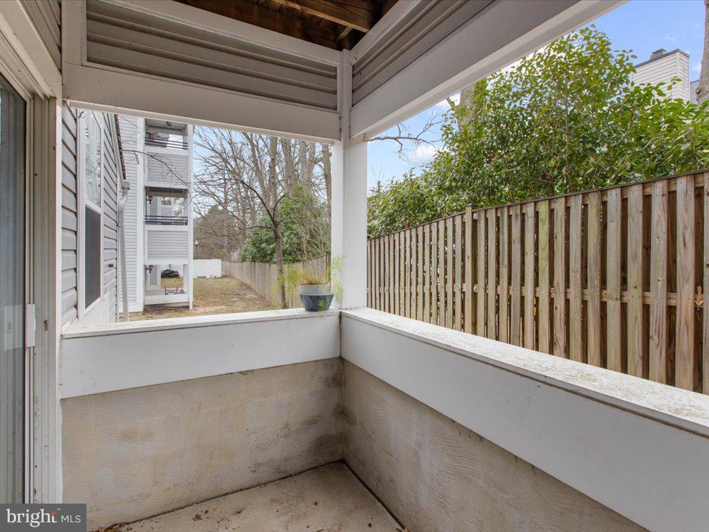 602 Moonglow Road, Unit 101 Odenton, MD 21113 - Photo 26 of 30 a view of balcony with floor to ceiling window and wooden fence