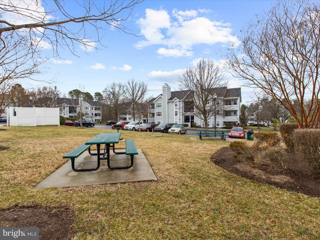 602 Moonglow Road, Unit 101 Odenton, MD 21113 - Photo 27 of 30 a view of a yard with cars