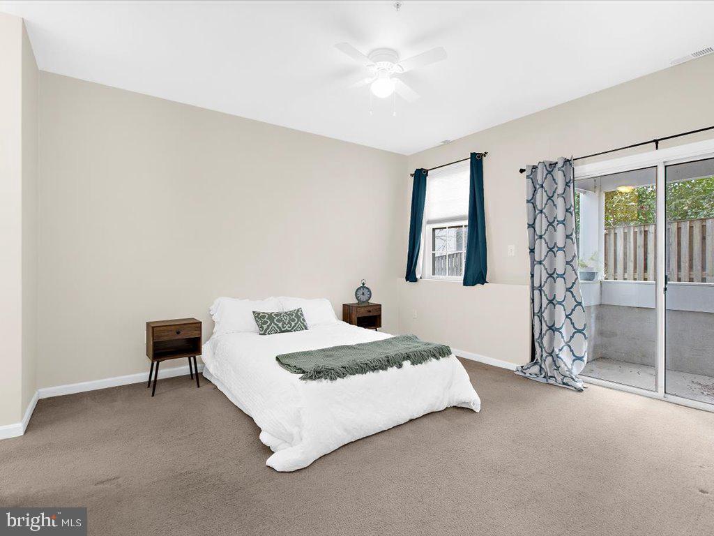 602 Moonglow Road, Unit 101 Odenton, MD 21113 - Photo 3 of 30 a bedroom with a bed and a chair
