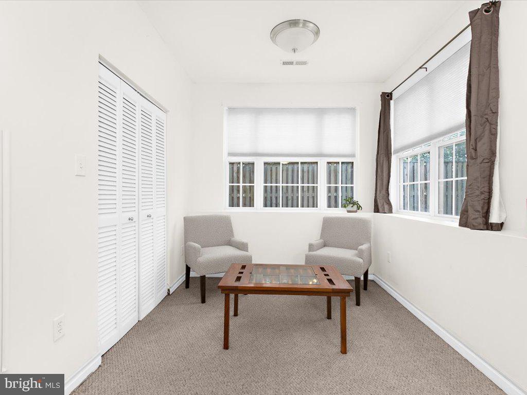 602 Moonglow Road, Unit 101 Odenton, MD 21113 - Photo 8 of 30 a living room with furniture and windows