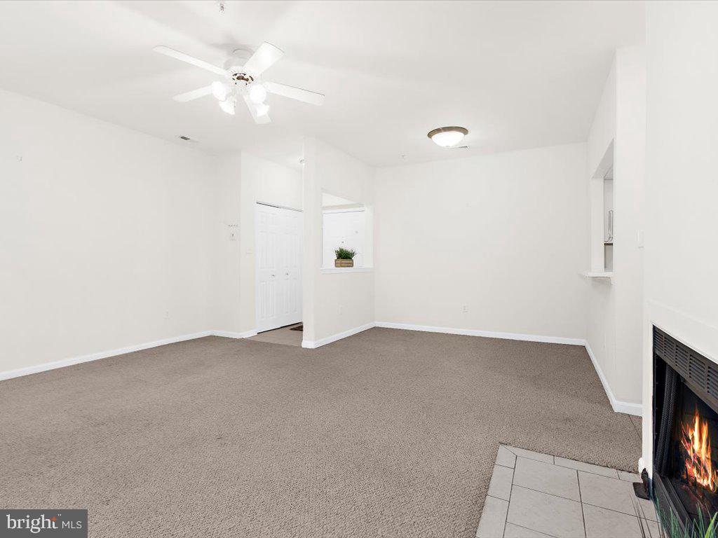 602 Moonglow Road, Unit 101 Odenton, MD 21113 - Photo 10 of 30 an empty room with a ceiling fan and a window