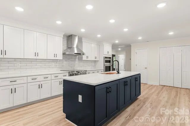 a kitchen with stainless steel appliances a sink and a refrigerator