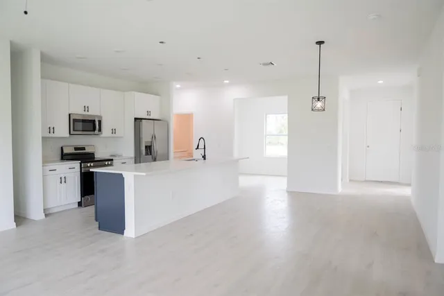 a kitchen with cabinets and stainless steel appliances