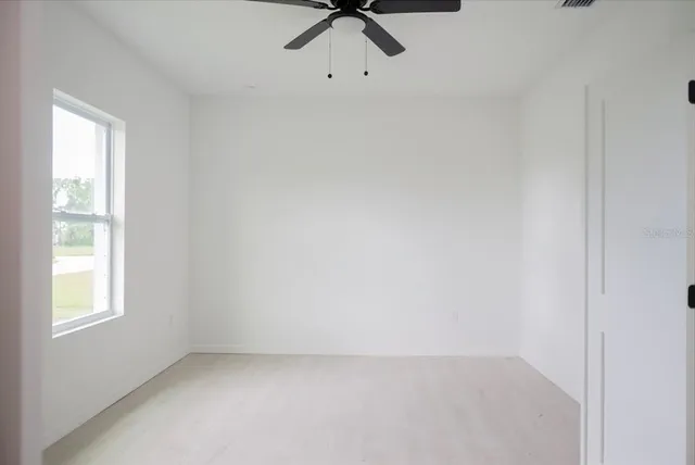 a spacious bathroom with a granite countertop sink and a mirror