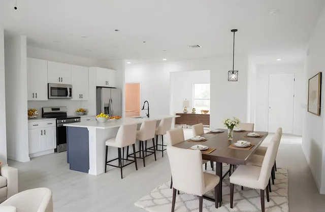 a kitchen with a sink a stove and cabinets