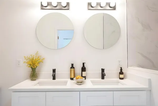 a bedroom with a bed and a potted plant