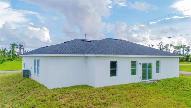 a kitchen with stainless steel appliances a stove a sink a refrigerator cabinets and a window