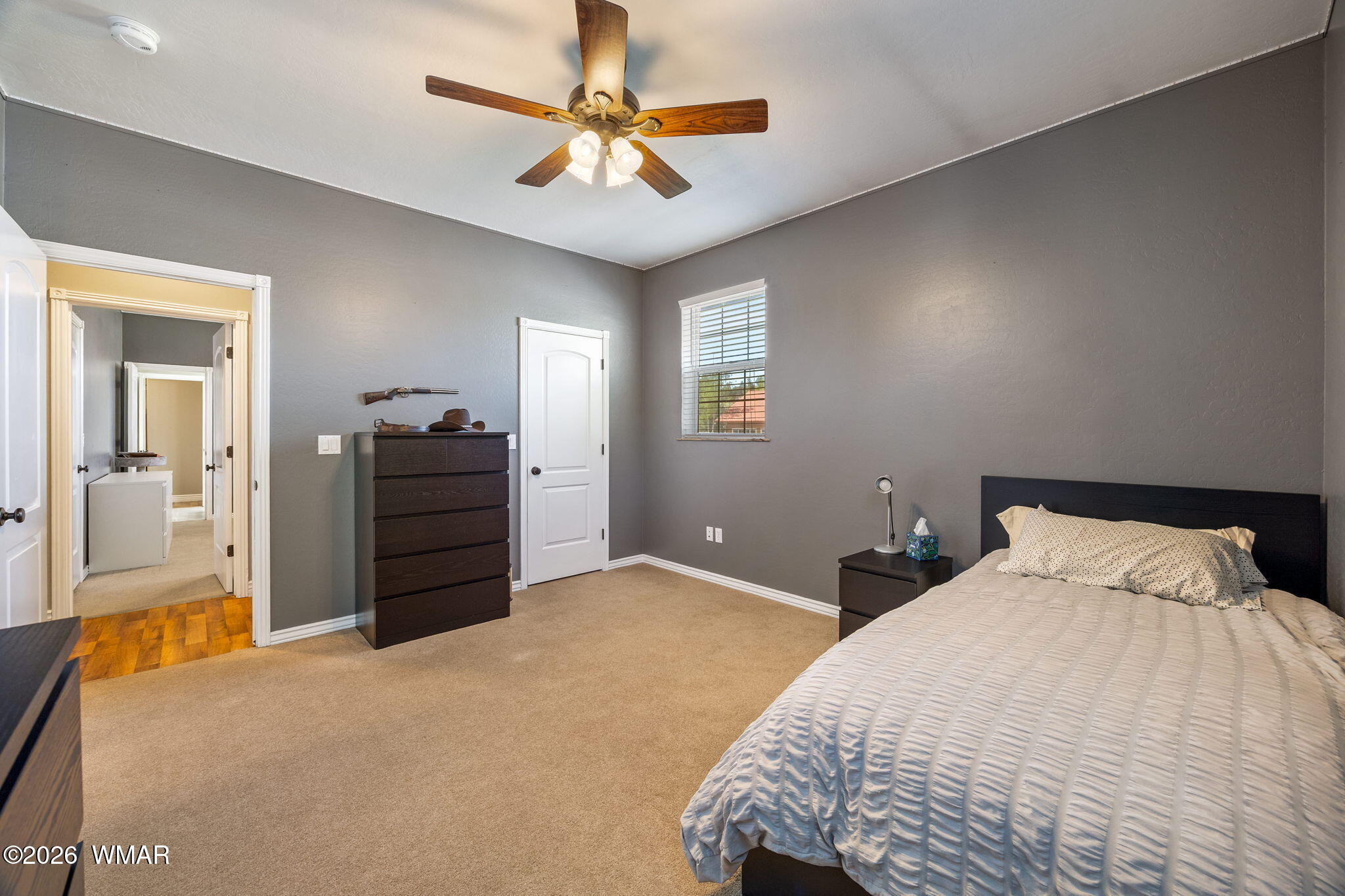1940 Stonegate Way Heber, AZ 85928 - Photo 34 of 62 a bedroom with a large bed and a chandelier