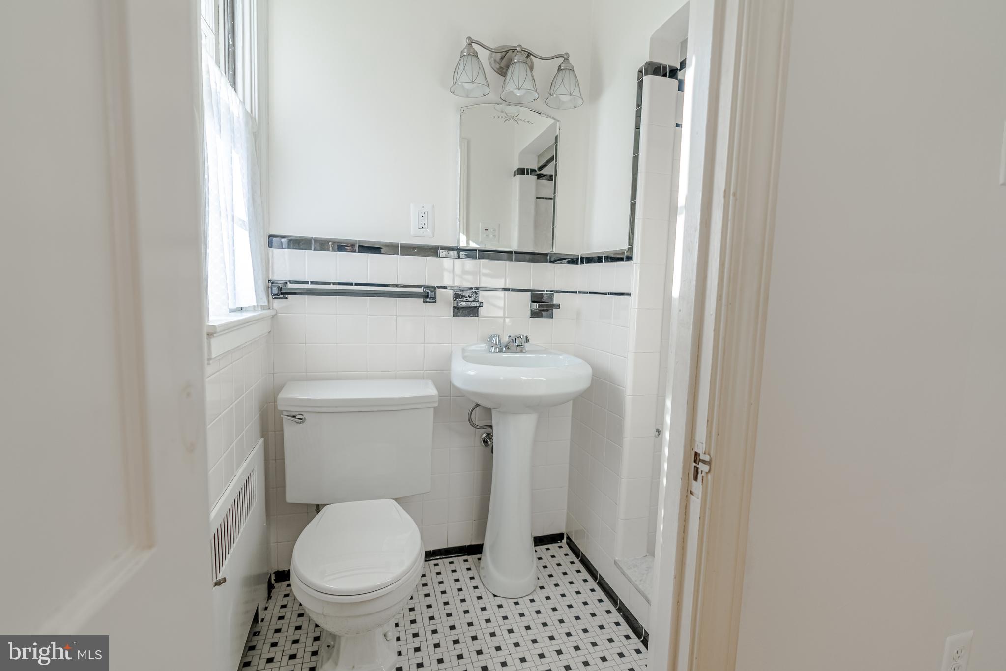 3718 Delverne Road Baltimore, MD 21218 - Photo 13 of 24 a bathroom with a sink toilet and a mirror