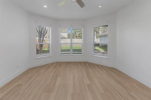 a view of a room with wooden floor and white walls