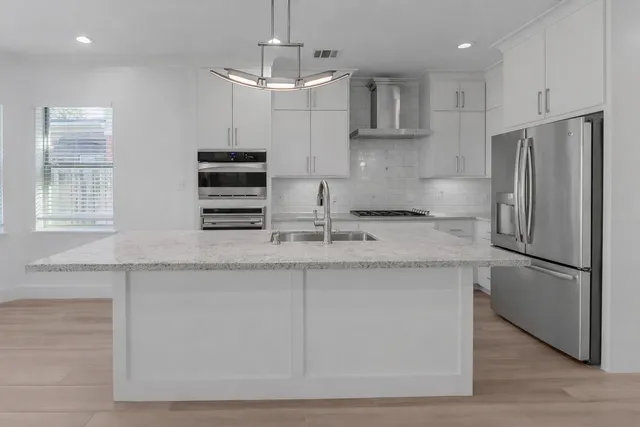a kitchen with a sink stainless steel appliances and cabinets