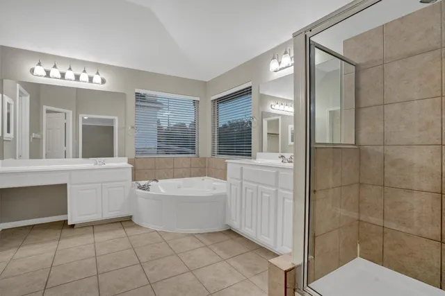 a bathroom with a bathtub shower and sink