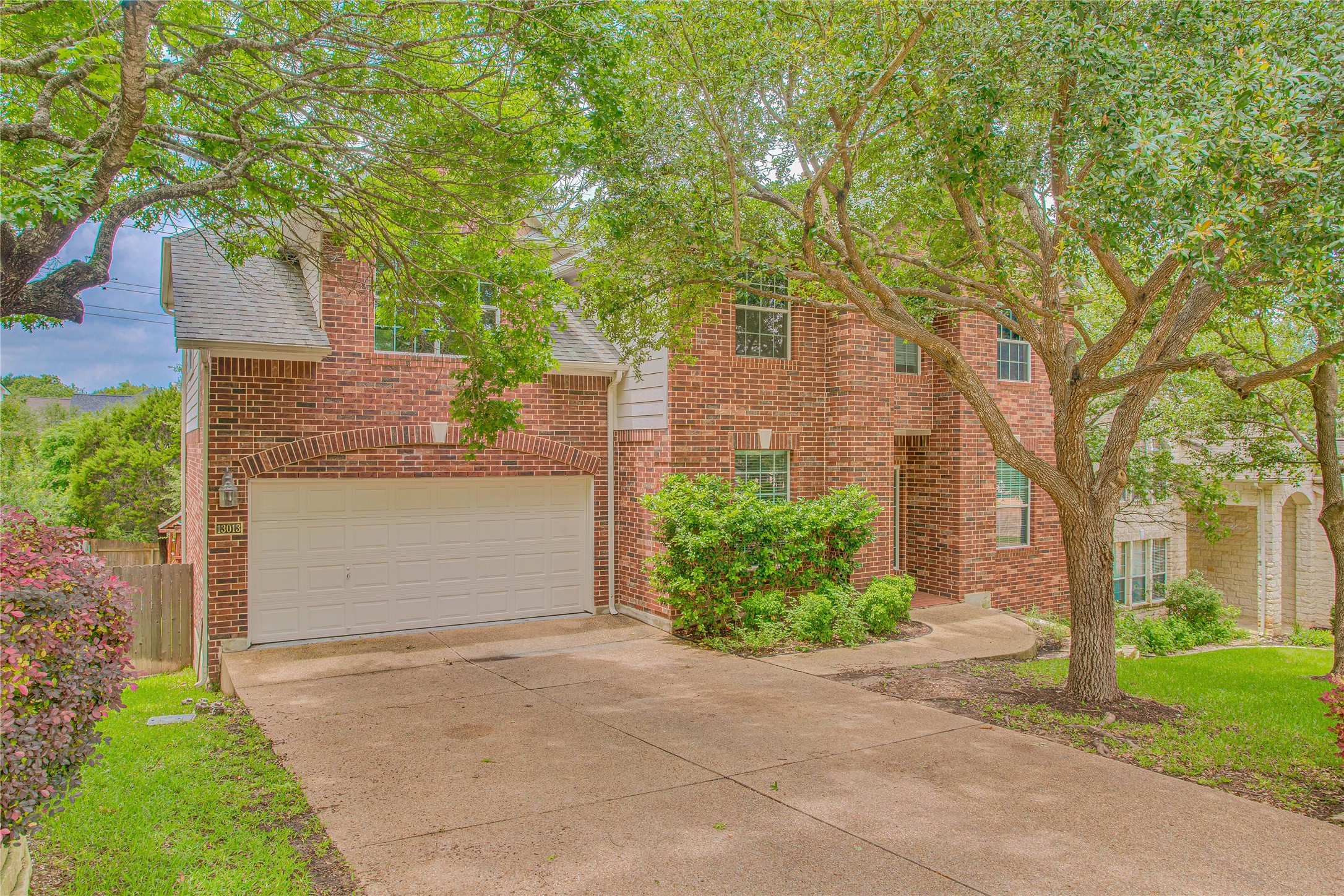 13013 Titus Court Austin, TX 78732 - Photo 2 of 30 front view of a house with a yard and an trees