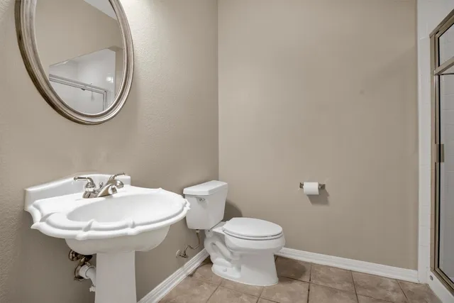 a white toilet sitting next to a bathroom sink