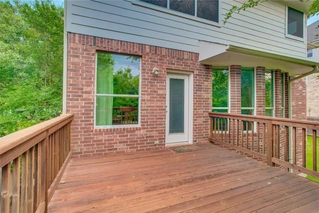 a view of a brick house with wooden floor and a floor to ceiling window
