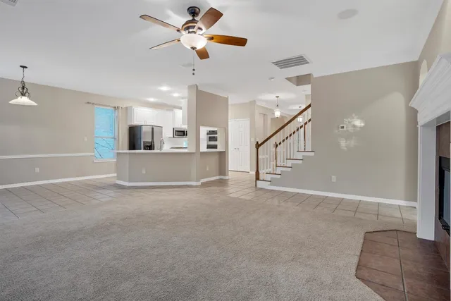 a view of a livingroom with a ceiling fan and window