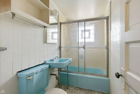 a bathroom with a sink mirror toilet and shower