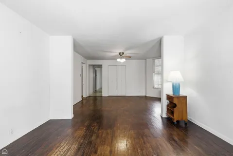 a view of an empty room with wooden floor