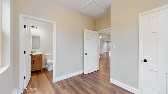 a view of a hallway with wooden floor and closet area
