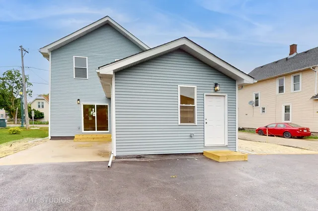 a front view of house with yard and trees