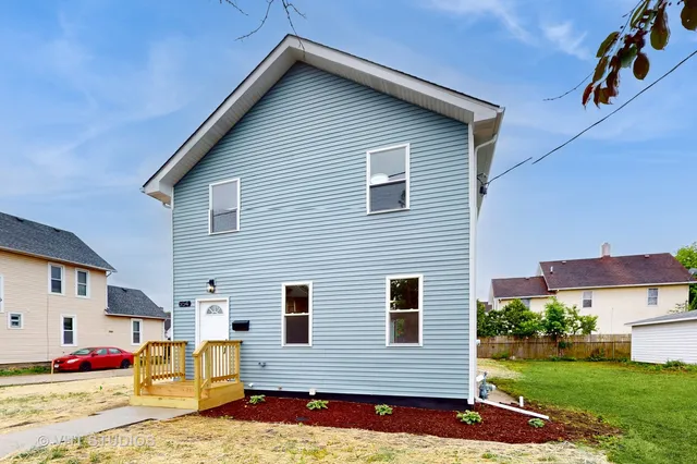 a view of backyard of house with outdoor seating