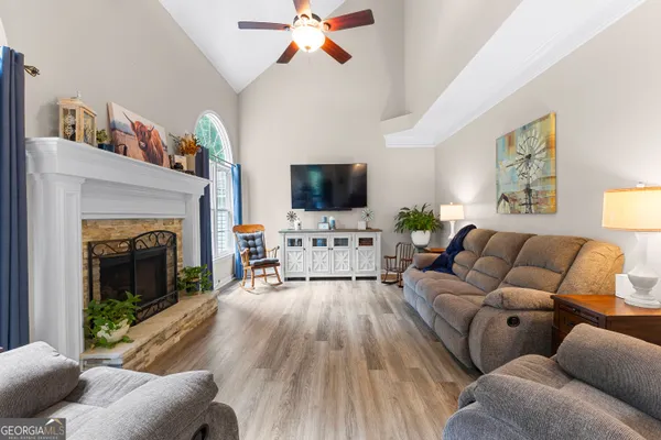 a living room with a fireplace and a large window