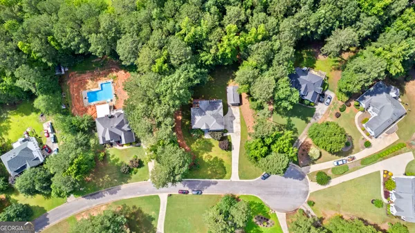 an aerial view of a house with a yard