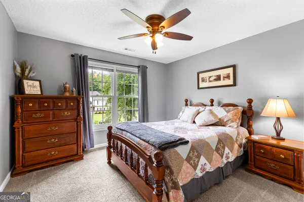 a bedroom with a bed and a large window