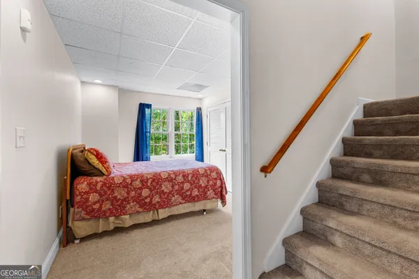 a bedroom with a large bed and a chandelier