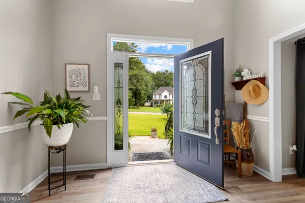 a view of entryway and hall with wooden floor